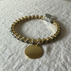 Gold tone slip on faux gem bracelet with gold charm